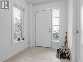 Stratford townhouse for rent - A white door is in a room with a window and a bag on the floor.