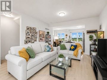 Stratford townhouse for rent - A living room with a white couch and a glass coffee table.