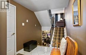 London South (South R) house for rent - A room with a staircase and a chair with a suitcase.