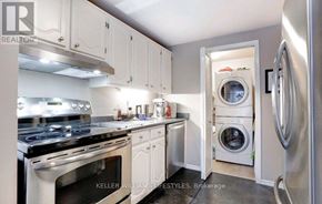 London South (South R) house for rent - A modern kitchen with white cabinets and stainless steel appliances.