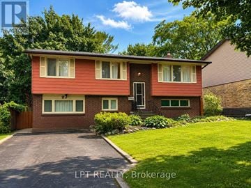 London North (North K) apartment for rent - A red brick house with a brown roof and a green lawn in front.