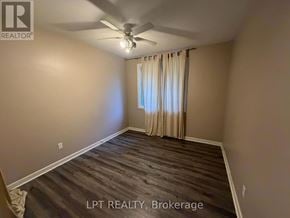 London North (North K) apartment for rent - A room with a ceiling fan and a window with curtains.