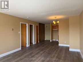 Prescott apartment for rent - A spacious room with wooden floors and a chandelier.