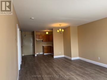 Prescott apartment for rent - A room with a kitchenette and a dining table in the middle.
