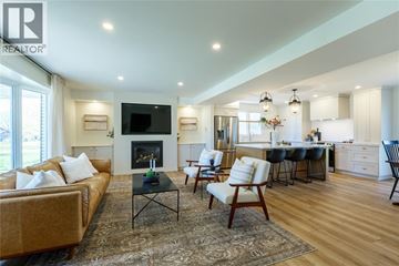 Sarnia apartment for rent - A living room with a fireplace and a television on the wall.