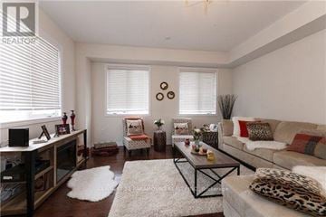 Mississauga (East Credit) townhouse for rent - A living room with a leopard print couch and a white rug.