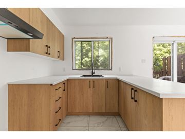 Gatineau (Gatineau) condo for rent - A kitchen with wooden cabinets and a window.