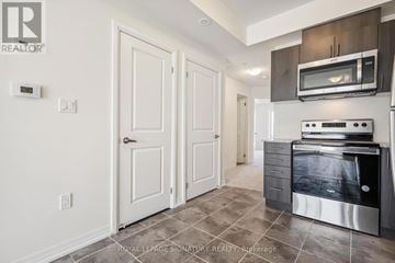 Toronto (Malvern) townhouse for rent - A kitchen with a stove top oven and a microwave above it.