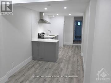Ottawa multi-family for rent - A modern kitchen with a sink and cabinets.