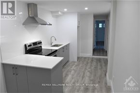 Ottawa multi-family for rent - A modern kitchen with a stove top oven and a sink.