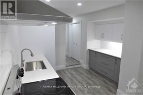 Ottawa multi-family for rent - A modern kitchen with a sink and cabinets.