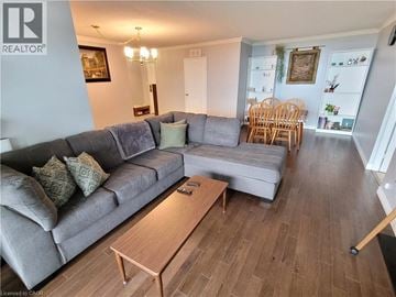 Burlington condo for rent - A living room with a grey couch and a wooden coffee table.