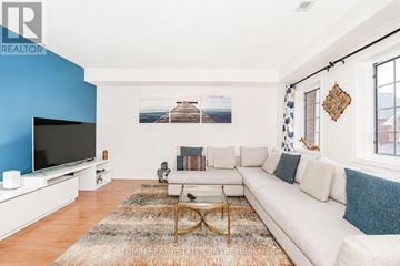 Markham (Wismer) townhouse for rent - A living room with a white couch and a television.