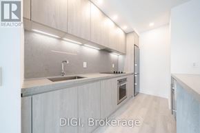 Toronto (Waterfront Communities) condo for rent - A modern kitchen with a sink and oven.