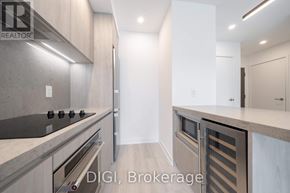 Toronto (Waterfront Communities) condo for rent - A modern kitchen with a stove top oven and a refrigerator.