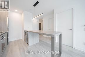Toronto (Waterfront Communities) condo for rent - A modern kitchen with a large island in the middle.