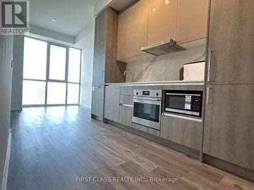 Vaughan (Vaughan Corporate Centre) condo for rent - A modern kitchen with wooden cabinets and stainless steel appliances.