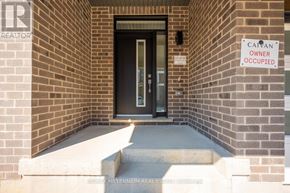 Brampton (Northwest Brampton) townhouse for rent - A sign on a brick wall says "CAYAN OWNER OCCUPIED".