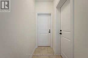 Brampton (Northwest Brampton) townhouse for rent - A white door is in a hallway with a RE/MAX real estate logo.