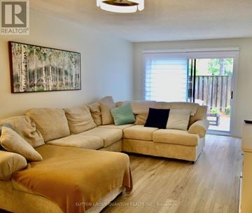 Mississauga (Meadowvale) townhouse for rent - A living room with a large beige couch and a painting on the wall.