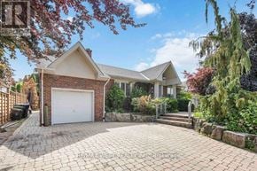 Toronto (Maple Leaf) apartment for rent - A house with a white garage door is for sale in West Hertfordshire.