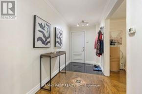 Toronto (Maple Leaf) apartment for rent - A hallway with a coat rack and two framed pictures on the wall.