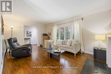Toronto (Maple Leaf) apartment for rent - A living room with a black leather chair and a white sofa.