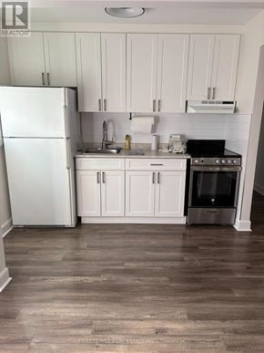 Toronto (Mimico) condo for rent - A living room with a couch, chair, and rug.