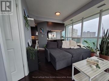 Mississauga (Clarkson) condo for rent - A living room with a grey couch and a coffee table.