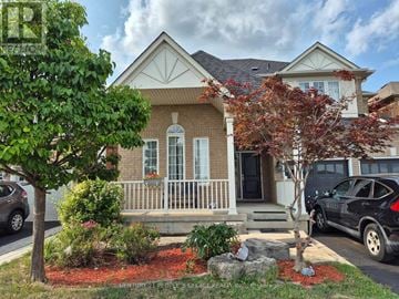 Brampton (Credit Valley) apartment for rent - A house with a white porch and a black car parked in front.