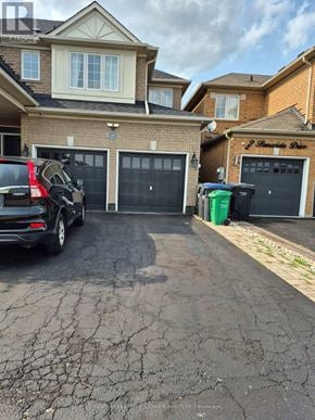 Brampton (Credit Valley) apartment for rent - A black SUV is parked in a driveway in front of a house.