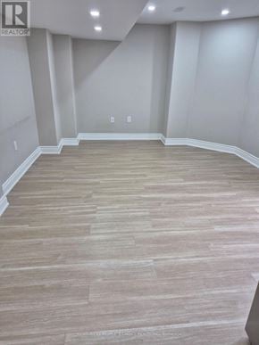 Brampton (Credit Valley) apartment for rent - A room with wooden flooring and white walls.
