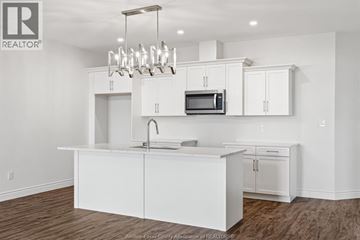 Amherstburg apartment for rent - A white kitchen with a microwave and a sink.