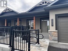 Brockville apartment for rent - A modern house with a black gate in front.