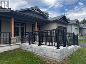 Brockville apartment for rent - A house with a black fence and a grey roof.
