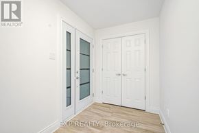 Clarence-Rockland townhouse for rent - A white interior with a glass door and a wooden floor.
