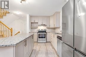 Clarence-Rockland townhouse for rent - A kitchen with a stove and refrigerator.