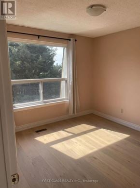 Toronto (Hillcrest Village) apartment for rent - A room with a large window and wooden flooring.