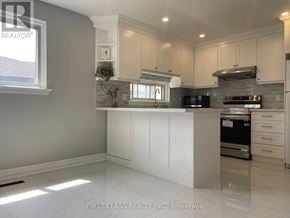 Toronto (Hillcrest Village) apartment for rent - A kitchen with white cabinets and a marble floor.