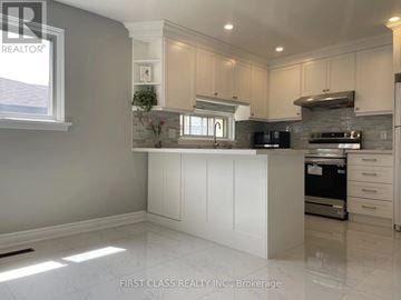 Toronto (Hillcrest Village) apartment for rent - A kitchen with white cabinets and a marble floor.
