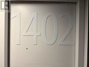 Toronto (Moss Park) condo for rent - A glass door with the number 1402 and the words "Royal LePage Signature Realty, Brokerage" on it.