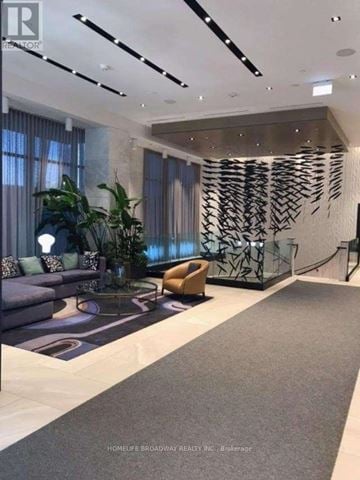 Toronto (Waterfront Communities) house for rent - A modern living room with a grey carpet and a large abstract art piece on the wall.