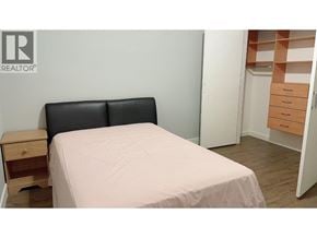 Burnaby apartment for rent - A bedroom with a bed, nightstand, and a dresser with drawers.