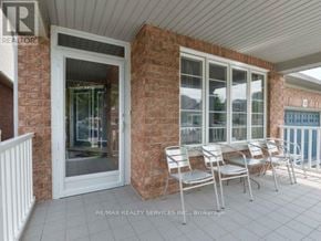 Brampton (Bramalea North Industrial) apartment for rent - A patio with a white chair and a glass door.