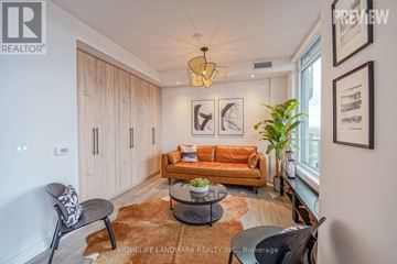 Toronto (South Parkdale) condo for rent - A living room with a brown rug and a brown couch.