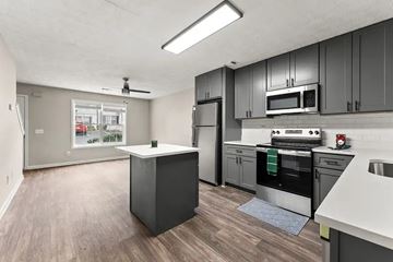 Winder apartment for rent - A kitchen with a refrigerator, microwave, oven, and sink.