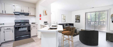 Gainesville apartment for rent - A modern kitchen with a black oven and white cabinets.