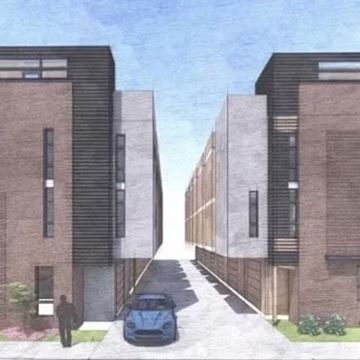 Denver apartment for rent - A blue car is parked on the street between two buildings.