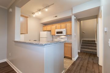 Lawrence apartment for rent - A kitchen with wooden cabinets and a white counter.