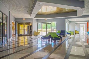 Macon apartment for rent - A spacious lobby with a reflective floor and a ceiling with wooden slats.